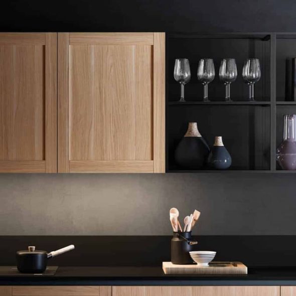 a kitchen with black countertops and wooden cabinets