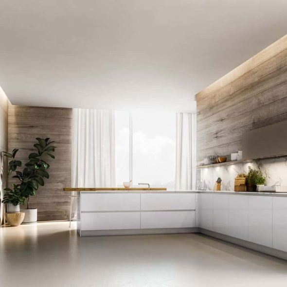 a kitchen with a wood wall and white cabinets