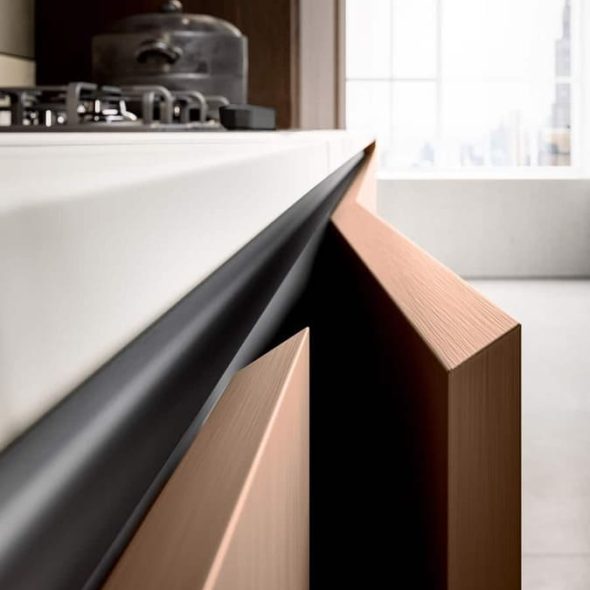 a kitchen with a white countertop and a black and brown cabinet