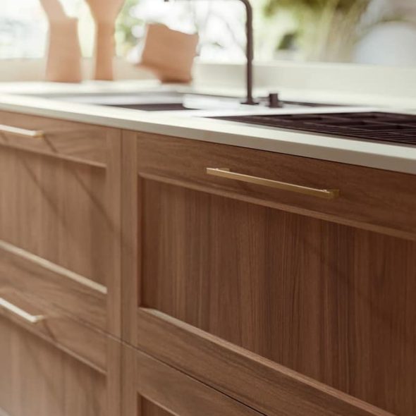 a kitchen with a sink and wood cabinets