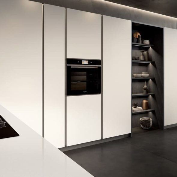 a kitchen with white cabinets and shelves